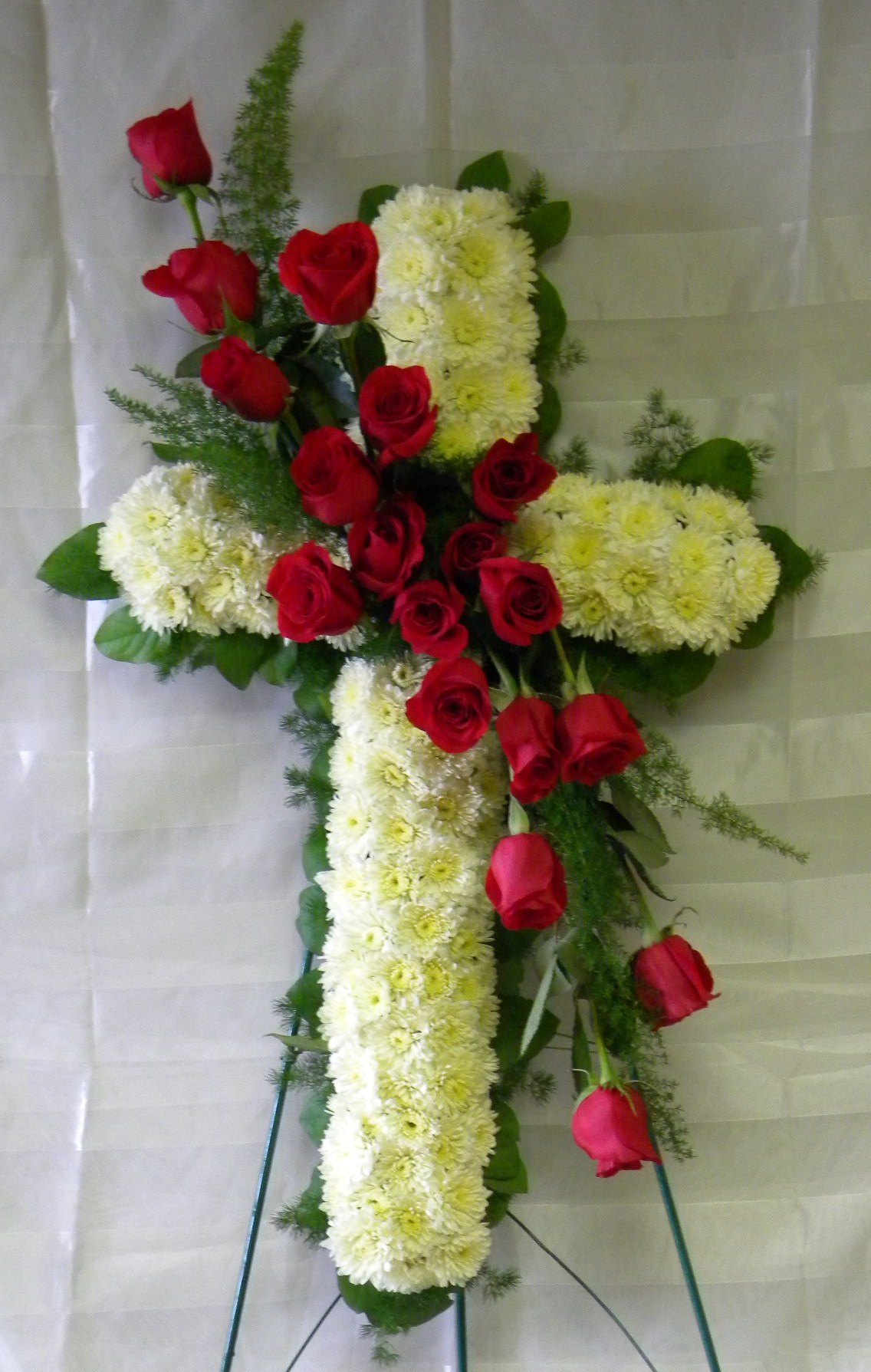 Sympathy flowers sympathy cross with white flower covering the cross and red roses down the center